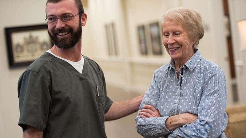 Nurse standing next to a senior woman